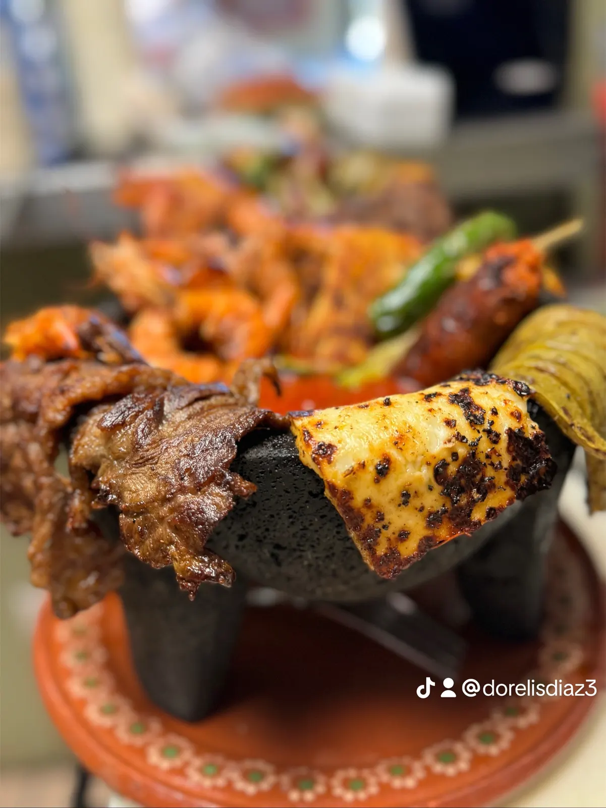 Sizzling molcajete with carne asada and shrimp